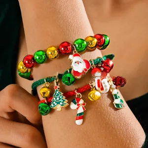 Close-up of three festive Christmas bracelets with Santa Claus and tree charms
