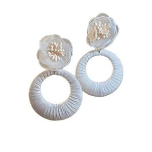 White fabric flower earrings with bohemian thread-wrapped hoops for a summer look