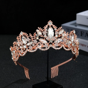 Detailed view of rose gold bridal crown with crystal leaf patterns and side combs