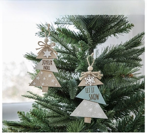 Detail of wooden Christmas tree pendants with JOYEUX NOEL text and rustic jute bows