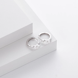Detail of S925 sterling silver hoop earrings with white flower and zircon stones