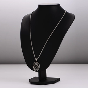 Vintage silver embossed family pendant necklace displayed on a black portrait model