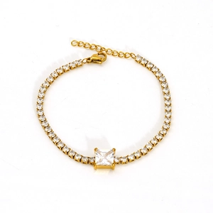 Macro detail of gold stainless steel tennis bracelet with square-cut center zircon stone
