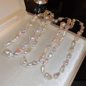 Detailed macro shot of irregular baroque pearl necklace in an elegant jewelry gift box