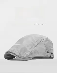 Detail of grey camouflage newsboy cap featuring breathable mesh and adjustable buckle
