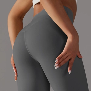 Close-up of dark grey high-waisted yoga leggings showing seamless hip-lifting stitching