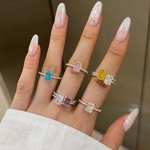 Close-up of hand wearing colorful rectangular cubic zirconia rings in S925 sterling silver