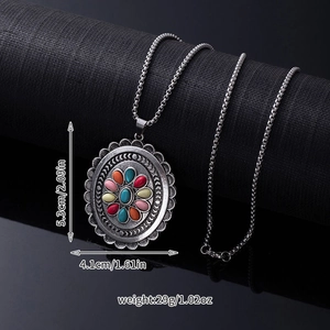 Detail view of bohemian vintage oval pendant with turquoise and multi-color stones