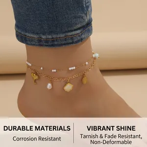 Close-up of double-layer stainless steel anklet with elephant, leaf and pearl charms