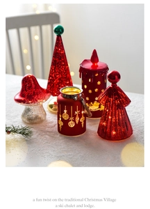 Detailed view of red glass mushroom and tree LED Christmas ornaments with warm glow