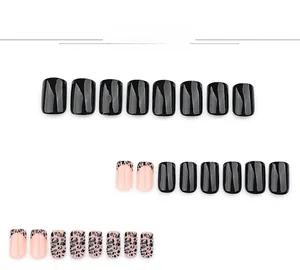 Short square press-on nails featuring black and leopard print designs on a white background