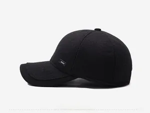 Side view detail of a warm black winter baseball cap with textured wool and SPORT label