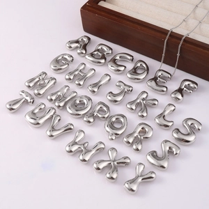 Silver chubby letter A-Z pendant set with chain and wooden jewelry box background