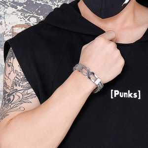 Close-up of silver titanium steel hip hop bracelet with unique geometric links on wrist