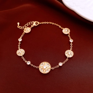 Detailed view of 18K gold plated bracelet with star-etched circular pendants and crystals