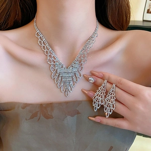Close-up of sparkling silver rhinestone choker necklace and matching tassel earrings set