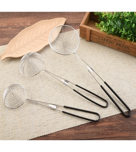 Three sizes of stainless steel slotted spoons with black handles on a wooden table