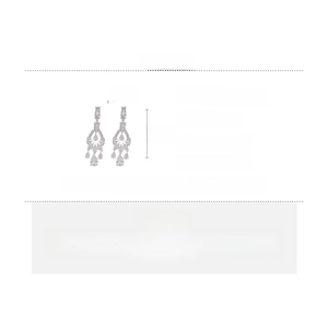Detailed view of elegant zircon droplet earrings with silver needles and copper base
