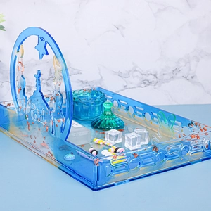 Macro view of blue acrylic Eid tray with gold foil, mosque silhouette, and crescent moon