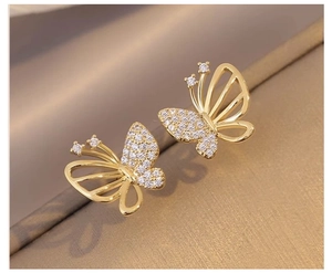 Detail of butterfly stud earrings with hollow design and pave-set white cubic zirconia