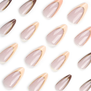 French almond press-on nails in nude and brown with elegant gold glitter detail