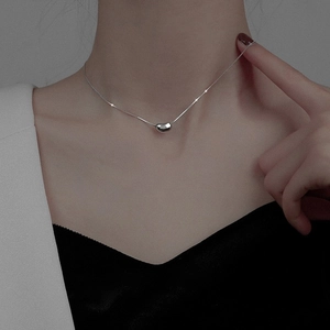 Minimalist silver titanium steel bean necklace shown on a model neck for women