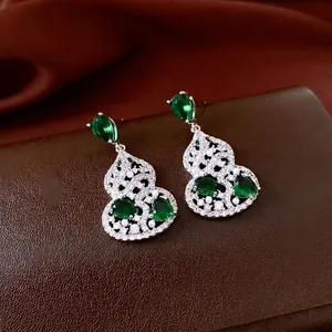 Elegant emerald green gourd drop earrings with silver frame and pearl accents
