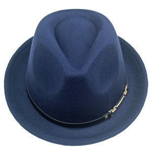 Detail of navy blue wool jazz hat featuring classic felt texture and a gold metal buckle