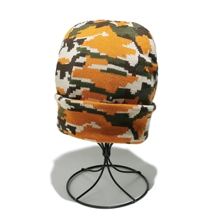Detail of pixel camouflage knit beanie featuring orange and green digital patterns