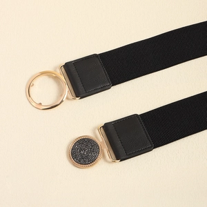 Close-up of black elastic belts featuring round golden metal buckles and PU leather ends
