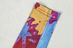 Detail of colorful abstract print fabric with durable stitching and functional thumb hole