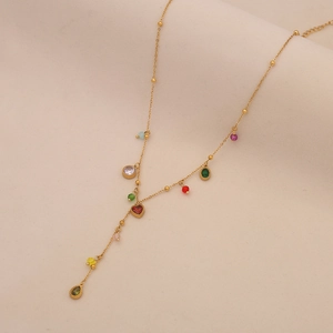 Detail of gold Y-shaped necklace with colorful crystal heart and cherry pendants
