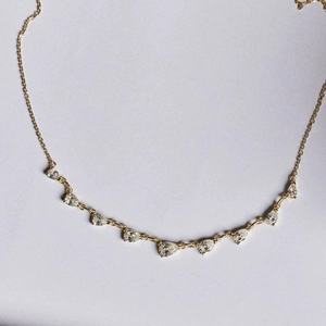 Elegant gold-plated necklace featuring nine teardrop-shaped zircon stones in a classic link chain