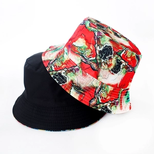 Close-up of reversible bucket hat stitching with red tie-dye and solid black options
