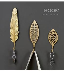 Three-piece set of gold leaf-shaped metal wall hooks for stylish home organization