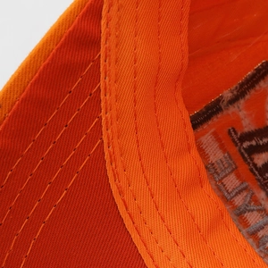 Macro detail of high-quality orange-red fabric stitching and embroidery on the baseball cap