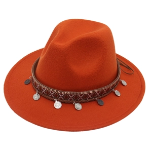 Close-up of bohemian felt fedora with ethnic woven band and silver metal pendants