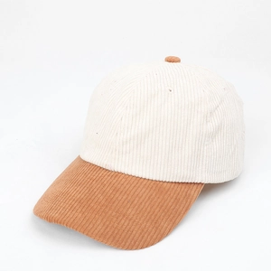 Corduroy baseball cap in cream and brown color block design shown from a side view