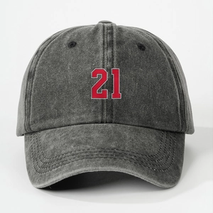 Close-up of number 21 embroidery on a washed dark gray cotton baseball cap