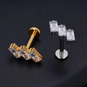 Macro view of G23 titanium labret stud with three sparkling rectangular zircons