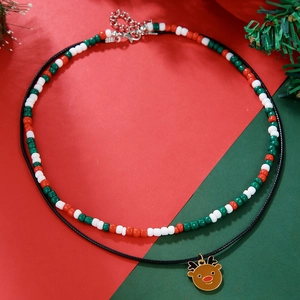 Close-up of double-layer Christmas necklace with colorful beads and golden reindeer charm