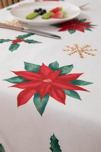 Close-up of waterproof polyester tablecloth with red poinsettia and green holly patterns