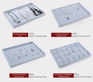Detailed comparison of four light grey velvet jewelry display trays with various slots