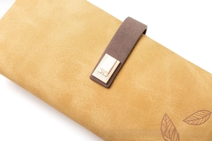 Close-up of vintage matte long wallet featuring leaf print and gold buckle detail
