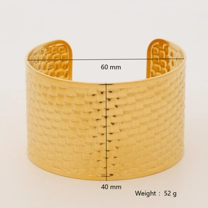 Detailed view of golden hammered wide cuff bracelet with 60mm diameter measurements