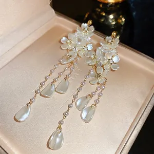 Elegant French flower earrings with pearl tassels and silver needles in a jewelry box