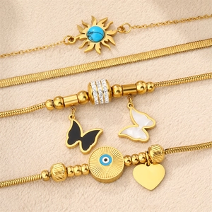 Gold 18K titanium steel bracelet set featuring butterfly, evil eye, and sun charms