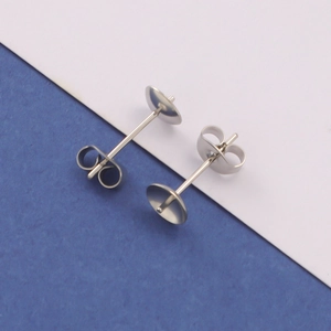 Macro detail of 18k gold plated stainless steel earring posts with butterfly backings