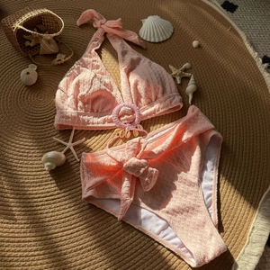 Detailed view of pink shell bikini with textured fabric and beach starfish decorations