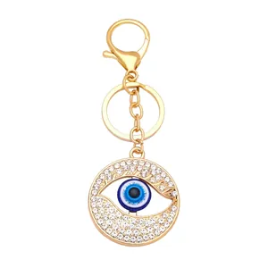 Golden Evil Eye keychain with white rhinestones and classic blue eye charm detail